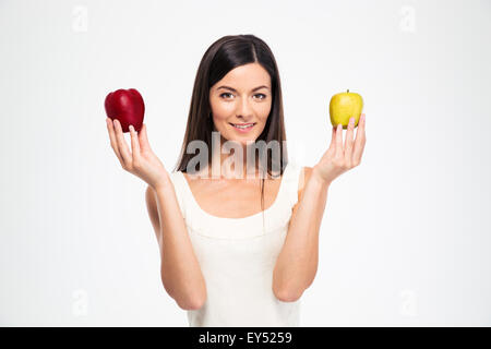 Happy beautiful woman holding two apples isolated on a white background Stock Photo