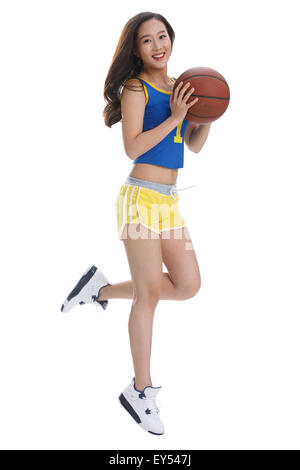 Portrait of young woman holding basketball Stock Photo