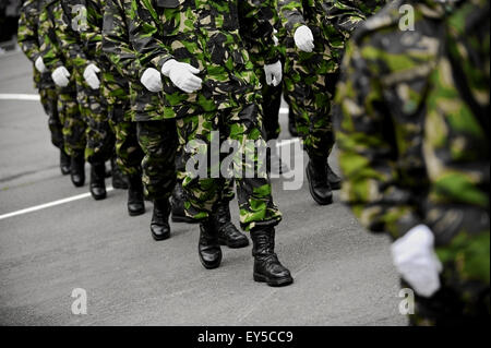 Soldiers in green camouflage uniform march in formation Stock Photo