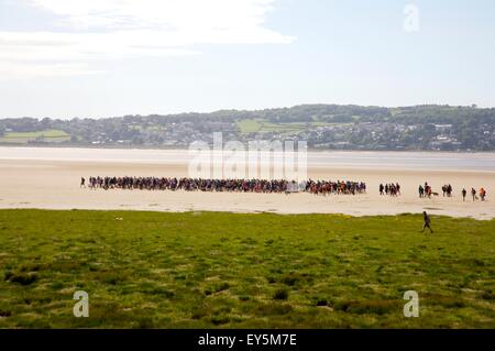 walkers gathering to cross Morecambe Bay from Arnside to Kent's Bank, guided by the Queen's guide to the sands. Cumbria. Stock Photo