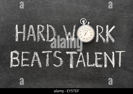hard work beats talent phrase handwritten on chalkboard with vintage precise stopwatch used instead of O Stock Photo