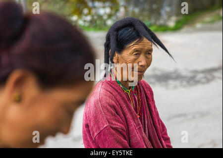 Woman from the Monpa tribe wearing traditional yak hair hat and traditional clothes Stock Photo