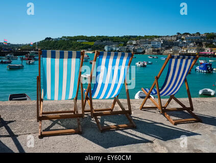 Deckchairs lined up on the seafront at St Ives, Cornwall, England, UK Stock Photo