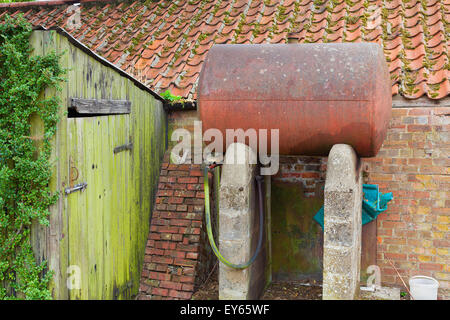 Domestic oil storage tank in a rusty state. Stock Photo