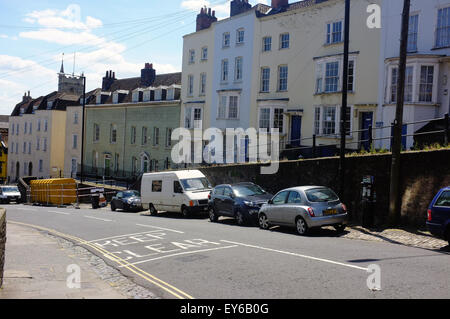 Vehicles parked beneath a row of houses along St Michael's Hill near Bristol University in the UK. Stock Photo