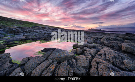 The approach to Dunstanburgh Castle from the south Stock Photo