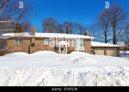 A family home in a north American suburb covered in snow. Stock Photo