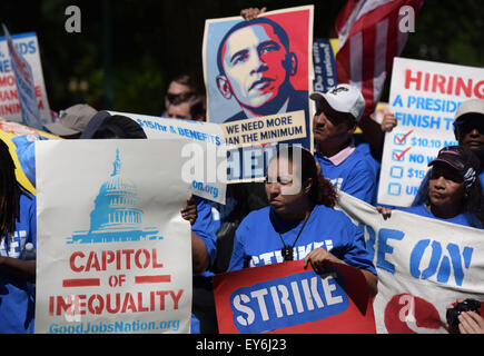 Washington, DC, USA. 22nd July, 2015. Protestors attend a strike rally, demanding to raise the federal minimum wage to 15 dollars per hour, on Capitol Hill in Washington, DC, the United States, on July 22, 2015. Credit:  Yin Bogu/Xinhua/Alamy Live News Stock Photo