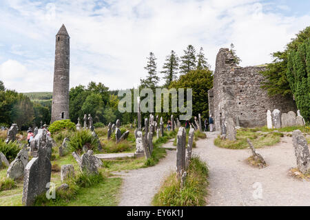 Ancient monastic Roundtower at Glendalough Graveyard, Ireland Stock Photo