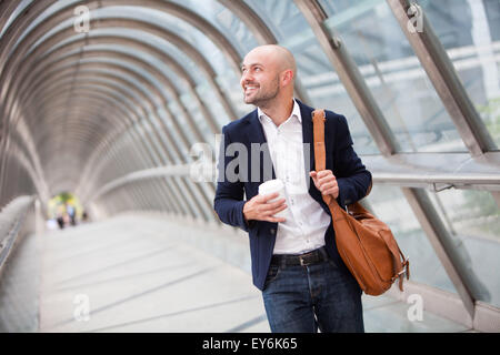 View of Young attractive man drinking coffee on his way Stock Photo