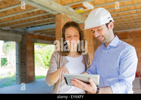 View of a Young woman and architect on construction site Stock Photo