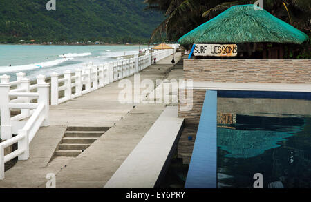A sign offers surfing lessons at Sabang Beach in Baler, Philippines. Stock Photo
