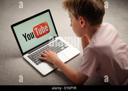 A Child watching Youtube videos on a laptop computer Stock Photo