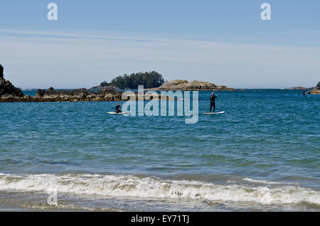 Stand up paddle board users on the waters off Chesterman Beach near Tofino on Vancouver Island, BC, Canada Stock Photo