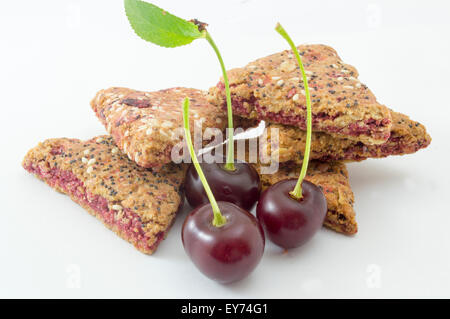 Integral cherry cookies with fresh cherry fruit  on white Stock Photo