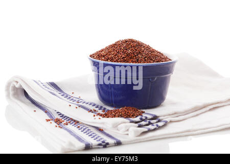 Red quinoa seeds in bowl isolated on white background. Healthy eating. Stock Photo