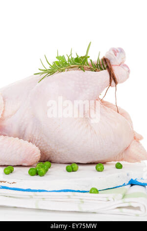 Raw organic whole chicken with herbs on cutting board isolated on white, prepared for baking. Culinary cooking. Stock Photo