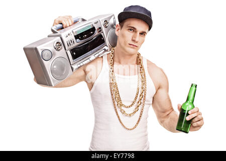 Young male rapper carrying a ghetto blaster over his shoulder and holding a bottle of beer isolated on white background Stock Photo