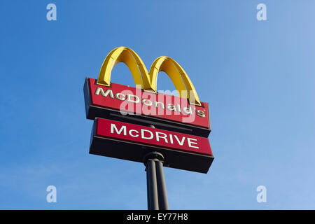 McDonalds sign against blue sky Stock Photo