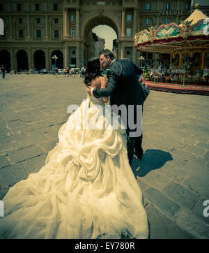 Bride and groom kissing in Piazzo della Repubblica, Florence, Italy. Stock Photo