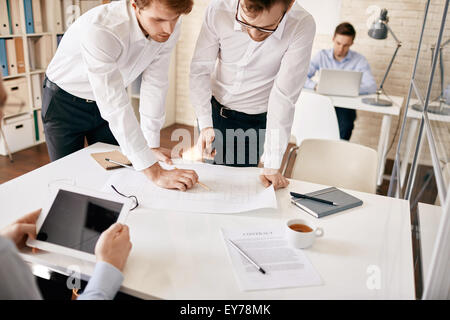 Two male architects discussing blueprint Stock Photo