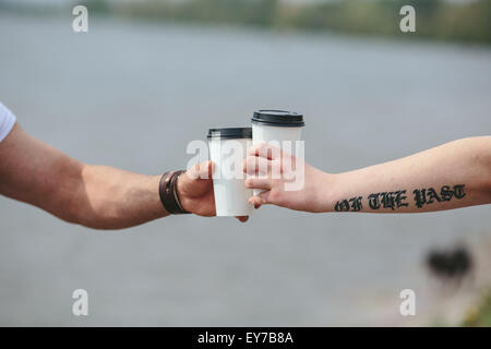 cheers using two cups of coffee Stock Photo