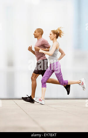 Mid adult couple running Stock Photo