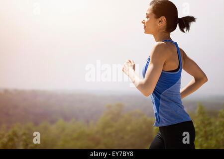 Young woman running outdoors Stock Photo