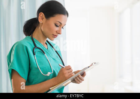 Female doctor making notes Stock Photo