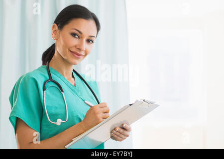 Female doctor making notes Stock Photo