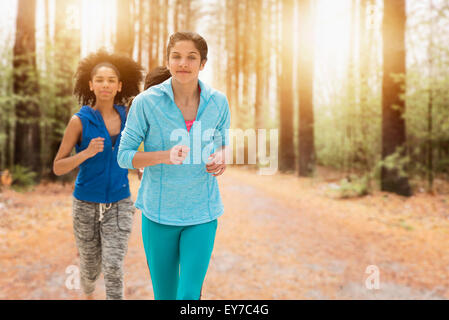 Portrait of teenage girls (14-15, 16-17) running Stock Photo