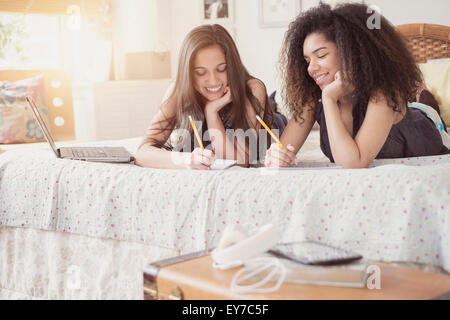 Teenage girls (14-15, 16-17) doing homework Stock Photo