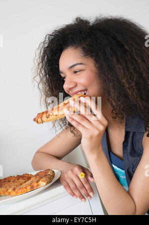 Teenage girl (16-17) eating pizza Stock Photo