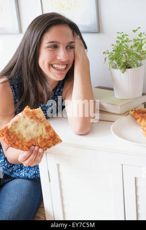 Teenage girl (14-15) eating pizza Stock Photo