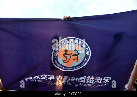 Beijing, China. 23rd July, 2015. Campers sign on the camp flag in Beijing, capital of China, July 23, 2015. The 6th Soong Ching Ling International Summer Camp, sponsored by China Soong Ching Ling Foundation, began in Beijing Thursday, and will last till July 29. © Jin Liangkuai/Xinhua/Alamy Live News Stock Photo