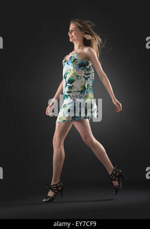 Studio shot of young woman walking Stock Photo