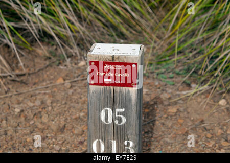 A wooden marker post on the Cami de Cavalls bridal path on the island of Menorca Spain Stock Photo