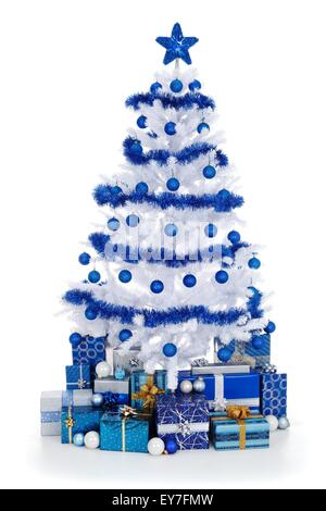 Artificial white Christmas tree on white, decorated with blue ornaments and garland, lots of presents under the tree Stock Photo