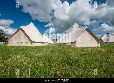 Lines of eco boutique tents and teepee camping at the Somersault Festival at Castle Hill Estate, in Filleigh, Devon, UK Stock Photo