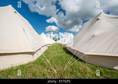 Lines of eco boutique tents and teepee camping at the Somersault Festival at Castle Hill Estate, in Filleigh, Devon, UK Stock Photo