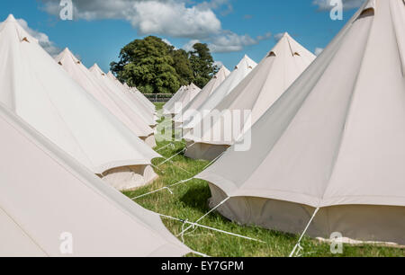 Lines of eco boutique tents and teepee camping at the Somersault Festival at Castle Hill Estate, in Filleigh, Devon, UK Stock Photo