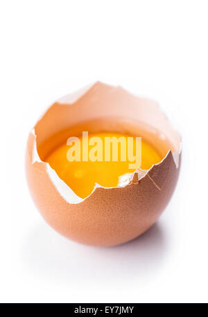 Yolk in broken egg isolated on white background Stock Photo