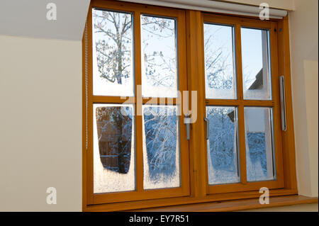 Evening frosty winter view through a window. Stock Photo