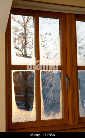 Evening frosty winter view through a window. Stock Photo