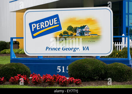 A logo sign outside of a chicken processing facility occupied by Perdue Farms, in Prince George, Virginia on July 19, 2015. Stock Photo