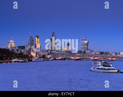 City of London and River Thames viewed from Waterloo Bridge at clear sunset dusk London UK Stock Photo