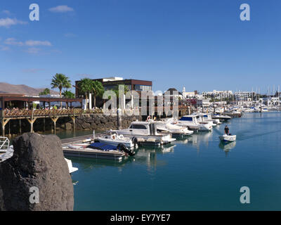 Marina Rubicon luxury marina with lava rock in foreground and Harbour Master Lanzarote Canary Islands Spain Stock Photo