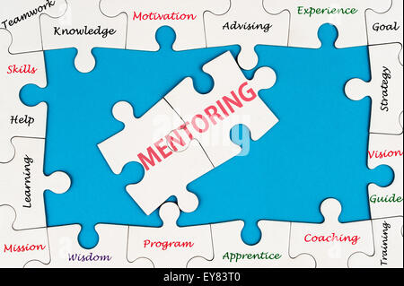 Mentoring concept word cloud on group of jigsaw puzzle pieces Stock Photo