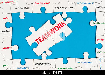 Teamwork concept word cloud on group of jigsaw puzzle pieces Stock Photo