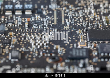 Detail view of condensers and microchips on a black mainboard Stock Photo